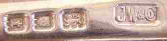 JW&Co into an oblong chamfered rectangle mark, Josiah Williams & Co (possibly), London 1934