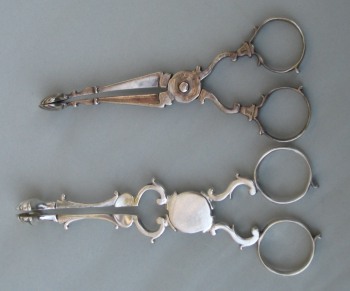 two silver tea tongs