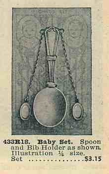 an ancient advertisement with sterling silver baby bib holder
