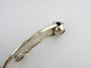 three sets of rings around the pipe are a traditional ornament of English bosun whistles