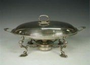 entre dish resting on its warmer frame with spirit lamp