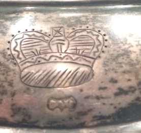 silver gorget engraved with a 'crown' and marked 'DW' recovered in a Creek Indian site in Alabama