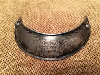 silver gorget engraved with a 'crown' and marked 'DW' recovered in a Creek Indian site in Alabama