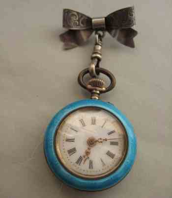 enameled watch and silver pin
