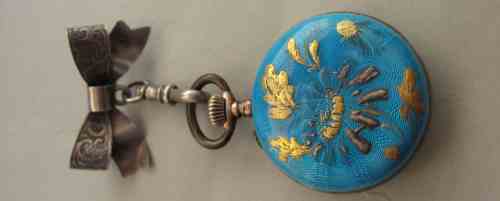 enameled watch and silver pin