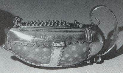 nutmeg grater with a cowrie shell enclosed by silver straps nutmeg grater with a cowrie shell enclosed by silver straps