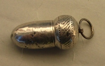silver acorn containing a cigarette-holder