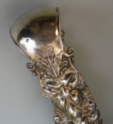 Austrian antique silver sugar tongs with masks and floral motifs