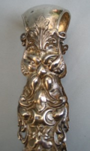 Austrian antique silver sugar tongs with masks and floral motifs
