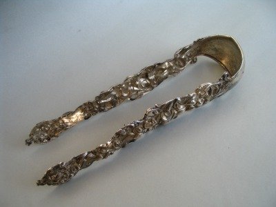 Austrian antique silver sugar tongs with masks and floral motifs